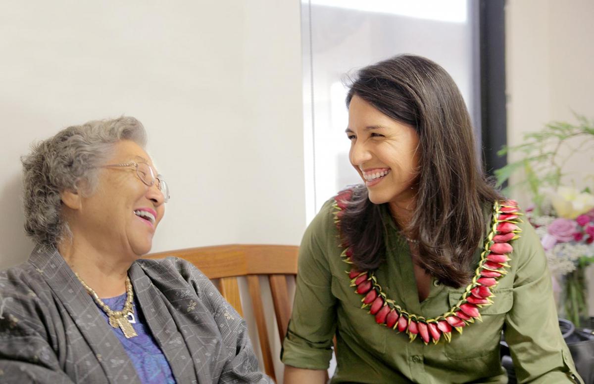 A photo of Tulsi Gabbard with a supporter